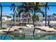 Close up of a waterfall feature in a waterfront pool with tropical decor at 12676 Bacchus Rd, Port Charlotte, FL 33981