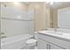 Bathroom with a tub and shower combination, white cabinetry, and a large mirror at 1352 Raspberry Dr, North Port, FL 34289