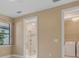 Bedroom leading to ensuite bathroom and laundry room, offering convenience and functionality at 1352 Raspberry Dr, North Port, FL 34289