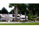 Inviting community entrance with lush landscaping and a serene pond with crane sculptures at 1352 Raspberry Dr, North Port, FL 34289