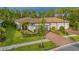 Charming single-story home with a well-manicured lawn, brick driveway, and elegant landscaping at 1352 Raspberry Dr, North Port, FL 34289