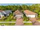 Charming single-story home featuring a tile roof, paver driveway, two-car garage, and professionally landscaped yard at 1352 Raspberry Dr, North Port, FL 34289