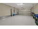 Spacious two-car garage with a light grey epoxy floor and plenty of storage space at 1352 Raspberry Dr, North Port, FL 34289