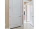 Hallway featuring white doors, neutral walls, and access to other areas of the home at 1352 Raspberry Dr, North Port, FL 34289