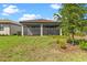 Covered and screened lanai, perfect for outdoor relaxation and enjoying the peaceful backyard view at 1352 Raspberry Dr, North Port, FL 34289