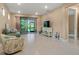 Bright living room with tile flooring and sliding glass doors to the outdoors at 1352 Raspberry Dr, North Port, FL 34289