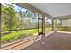A spacious screened patio featuring brick floors and great views of the green backyard at 1352 Raspberry Dr, North Port, FL 34289