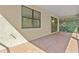 Outdoor patio space, featuring red-brick floor, and an exterior view of tall trees at 1352 Raspberry Dr, North Port, FL 34289