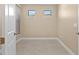 Bright, simple room with light tile flooring and two clerestory windows at 1352 Raspberry Dr, North Port, FL 34289