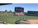 View of a stadium featuring a large video board, green grass, and stadium seating at 1352 Raspberry Dr, North Port, FL 34289