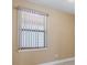 Window with vertical blinds and natural light coming through the glass at 1352 Raspberry Dr, North Port, FL 34289