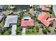Aerial view of a single-Gathering home featuring a pool, boat dock, and lush landscaping on the canal at 1425 Appian Dr, Punta Gorda, FL 33950