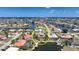 Waterfront property featuring a red tile roof, pool, and boat dock in a vibrant coastal community at 1425 Appian Dr, Punta Gorda, FL 33950