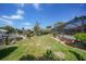Well-maintained backyard with lush green grass, mature landscaping, and a screened pool area with waterfront access at 1425 Appian Dr, Punta Gorda, FL 33950