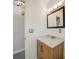 Bathroom with a modern vanity with a marble countertop and wood grain cabinets at 1425 Appian Dr, Punta Gorda, FL 33950