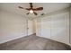 Neutral bedroom with ceiling fan, closet doors, and light-colored floors at 1425 Appian Dr, Punta Gorda, FL 33950