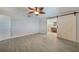 Bedroom featuring light wood-look floors and barn door leading to an en-suite bathroom at 1425 Appian Dr, Punta Gorda, FL 33950