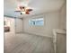 Bright bedroom features wood-look floors, sliding barn door, and stylish ceiling fan at 1425 Appian Dr, Punta Gorda, FL 33950
