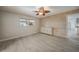 Light bedroom with wood-look floors, a feature wall, and a view to the front yard at 1425 Appian Dr, Punta Gorda, FL 33950