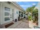 Welcoming entryway featuring a tiled porch and a lush tropical garden, creating a serene and inviting ambiance at 1425 Appian Dr, Punta Gorda, FL 33950