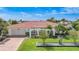 Charming single-story home with a well-manicured lawn, tiled roof, and an inviting front entrance with arched accents at 1425 Appian Dr, Punta Gorda, FL 33950