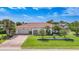 Beautiful single-story home featuring a red tile roof, lush landscaping, and a well-maintained lawn at 1425 Appian Dr, Punta Gorda, FL 33950