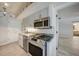 Well-lit kitchen features stainless steel appliances, granite countertops, and white tile backsplash at 1425 Appian Dr, Punta Gorda, FL 33950