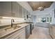Updated kitchen with stainless steel appliances and an opening to the outdoor entertaining space at 1425 Appian Dr, Punta Gorda, FL 33950