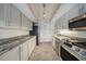 Bright kitchen with stainless steel appliances, light grey cabinets, and granite countertops at 1425 Appian Dr, Punta Gorda, FL 33950