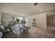 Spacious living room with tile floors, recessed lighting, and a large window showcasing the lush tropical backyard at 1425 Appian Dr, Punta Gorda, FL 33950