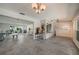 Bright, open-concept layout with tile flooring, offering seamless transitions between the living room, dining area, and kitchen at 1425 Appian Dr, Punta Gorda, FL 33950