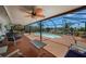 Relaxing screened pool area with comfortable seating, lush landscaping, and access to the waterfront canal at 1425 Appian Dr, Punta Gorda, FL 33950