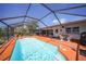 Beautiful backyard featuring a screened pool with a spacious deck, perfect for enjoying sunny days at 1425 Appian Dr, Punta Gorda, FL 33950