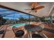 Inviting screened pool with a covered patio and ceiling fan, perfect for outdoor dining and entertaining by the waterfront at 1425 Appian Dr, Punta Gorda, FL 33950