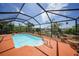 Inviting screened pool with lush tropical landscaping and access to the canal, creating a private outdoor oasis at 1425 Appian Dr, Punta Gorda, FL 33950