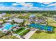 This aerial view showcases a beautiful pool, bocce court, and pickleball courts in a vibrant community at 1490 Mableton Dr, Port Charlotte, FL 33953