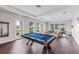 Clubhouse game room featuring a pool table, seating, and natural light at 1490 Mableton Dr, Port Charlotte, FL 33953