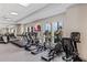 Modern fitness center with treadmills, ellipticals, and stationary bikes by large windows at 1490 Mableton Dr, Port Charlotte, FL 33953