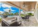 Outdoor patio with comfortable seating and dining areas, overlooking the community pool at 1490 Mableton Dr, Port Charlotte, FL 33953
