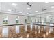 Spacious, mirrored exercise studio with wood floors, offering a bright and open space at 1490 Mableton Dr, Port Charlotte, FL 33953