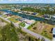 Aerial view of home located on a canal, featuring a private boat dock and screened-in pool at 15618 Aqua Cir, Port Charlotte, FL 33981