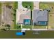 Aerial view of home with a private boat dock and screened-in pool, located next to a canal at 15618 Aqua Cir, Port Charlotte, FL 33981