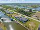 An expansive aerial view showcases waterfront homes with pools and boat docks along a winding canal at 15618 Aqua Cir, Port Charlotte, FL 33981