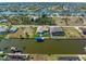 Aerial view of waterfront properties with private boat docks along a winding canal in a neighborhood at 15618 Aqua Cir, Port Charlotte, FL 33981