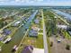A high-angle aerial view showcasing the waterfront homes along a canal in a residential community at 15618 Aqua Cir, Port Charlotte, FL 33981