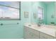Inviting bathroom boasts a marble vanity, decorative paintings, and refreshing light green walls at 15618 Aqua Cir, Port Charlotte, FL 33981