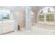Bright bathroom with soaking tub, a separate shower, and a classic design at 15618 Aqua Cir, Port Charlotte, FL 33981