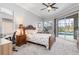 Bedroom features a desk and chair, and a sliding glass door with a view of the pool at 15618 Aqua Cir, Port Charlotte, FL 33981