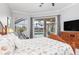 Bright bedroom with a view of the pool, comfortable furniture, and access to the outdoor space at 15618 Aqua Cir, Port Charlotte, FL 33981