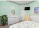 Inviting bedroom features coastal decor, wainscoting, a window with a view, and light mint walls at 15618 Aqua Cir, Port Charlotte, FL 33981